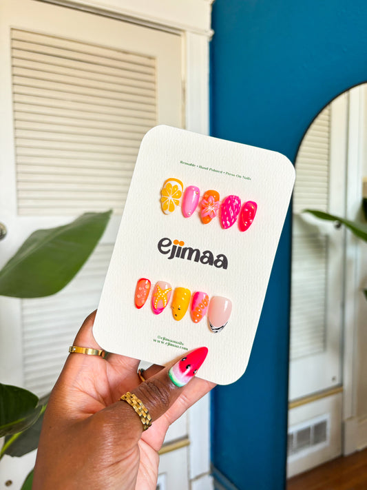 These coastal-inspired nails feature starfish, seashells, and ocean waves. A dreamy color palette of pinks, yellows, and whites captures the essence of a perfect day by the beach. Perfect for those going on vacation!