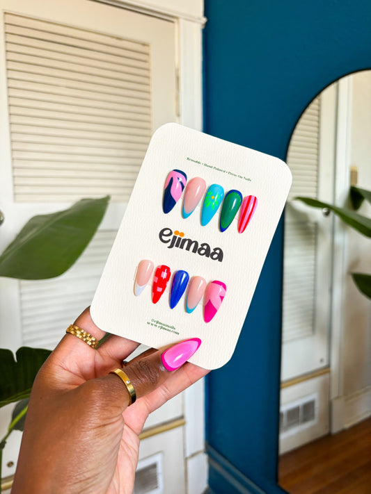 Hand holding a nail card of colorful press-on nails with 'ejimaa' branding. bright summer colors and floral inspirations.