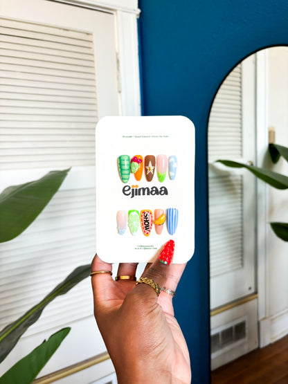 The 915 is a love letter to El Paso featuring iconic local elements. Tacos, prickly pear cacti, and the historic Plaza Theatre. Desert sunset colors create the perfect backdrop for this set. Each nail showcases a different piece of El Paso culture, celebrating the unique charm of the 915.